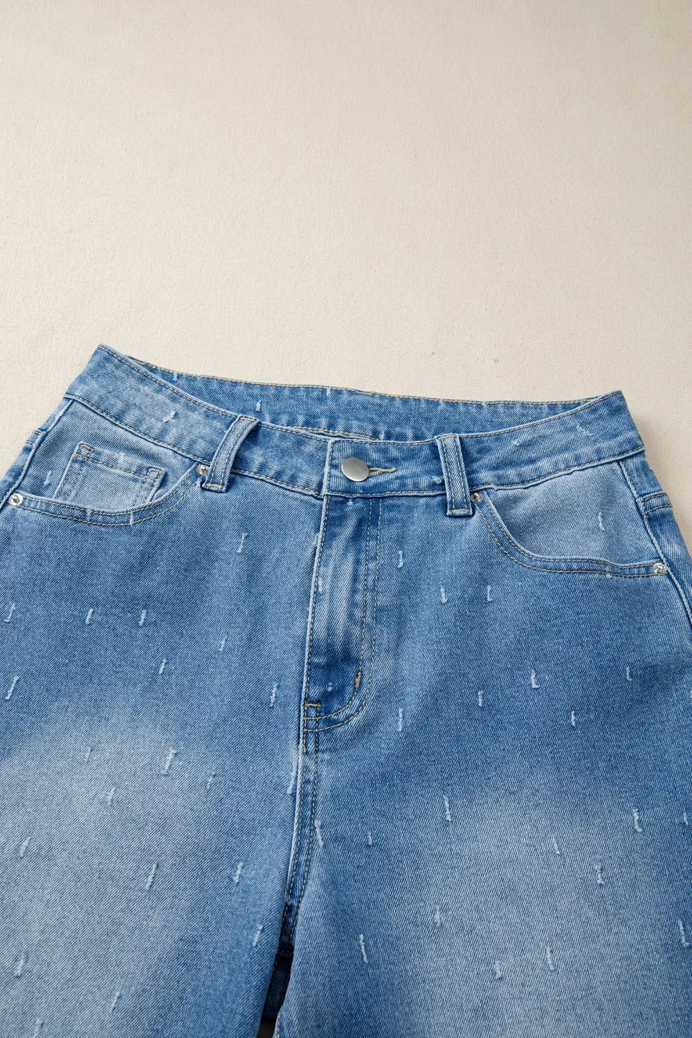 Jeans de control de abdomen con detalles desgastados y dobladillo sin rematar