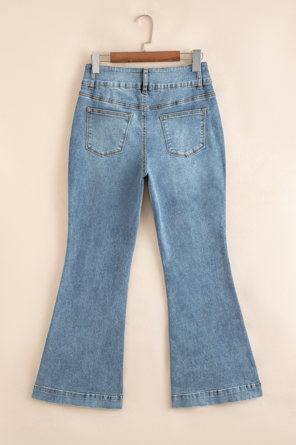 Jeans acampanados azul crepúsculo de cintura alta, con botones y ribete de vivo