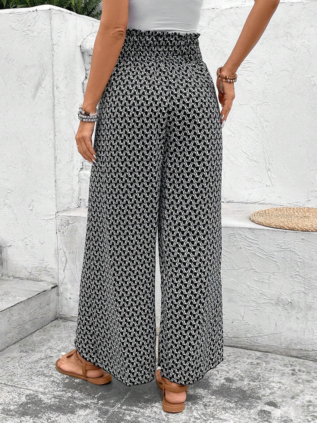 Pantalones negros de pierna ancha con estampado floral, fruncido y abertura lateral